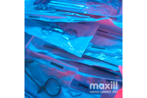 Dental instruments in sterilization pouches with blue and red lighting