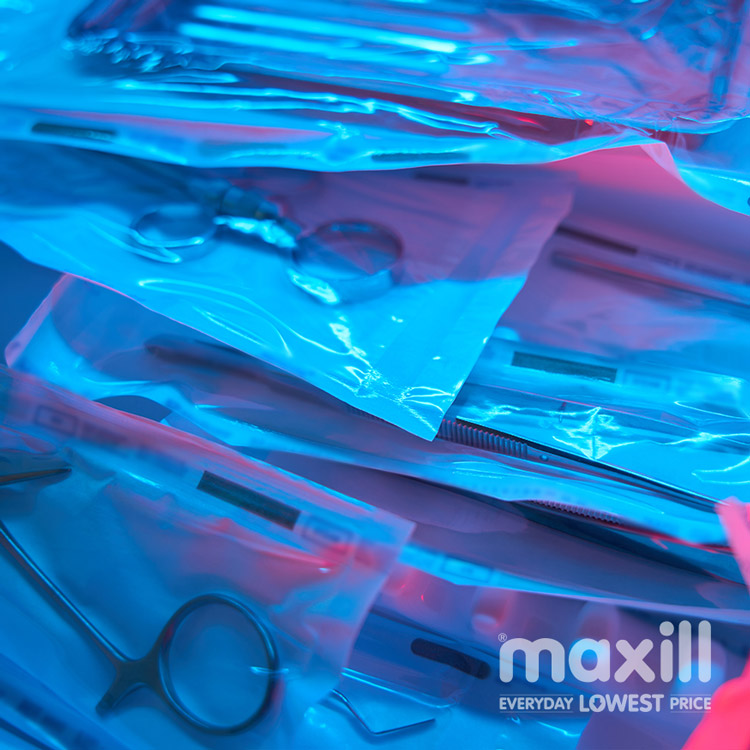 Dental instruments in sterilization pouches with blue and red lighting