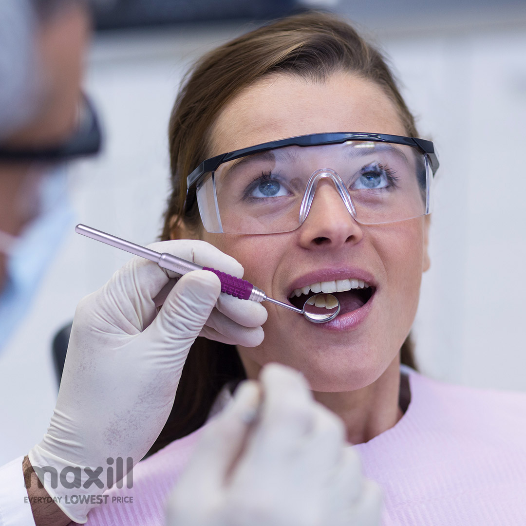 Woman patient receiving dental care while wearing protective eyewear