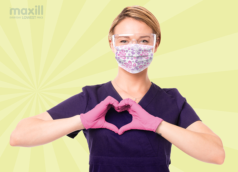 dental worker wearing pink nitrile gloves and a floral mask